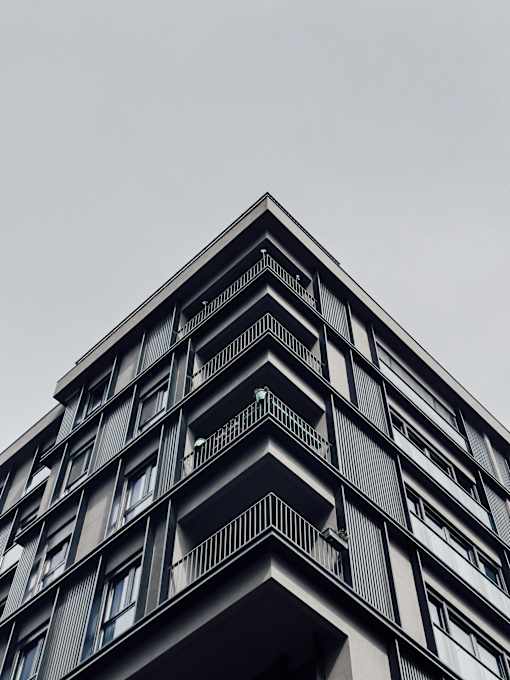 A tall building with balconies and windows.