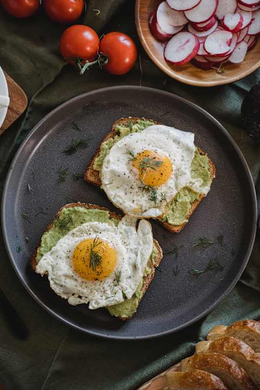 eggs on toast with avocado and a side of radishes