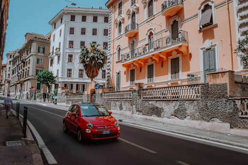 a red car driving down the street