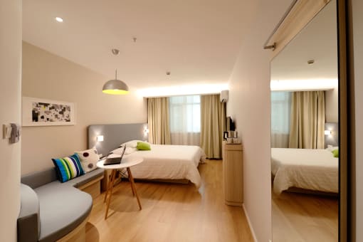 a hotel room with two beds and a desk