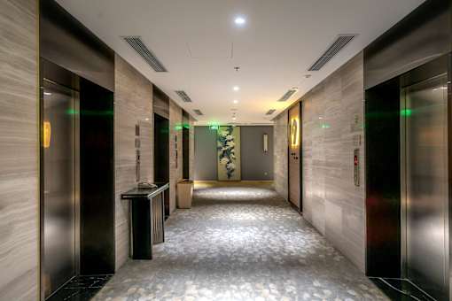 A long hallway with elevators on both sides.