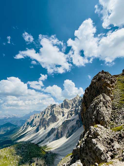 A rocky mountain peak with a clear blue sky above.