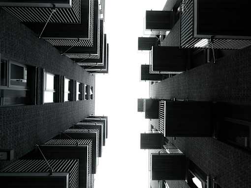 A black and white image of a building with a striped pattern on the walls and ceiling.