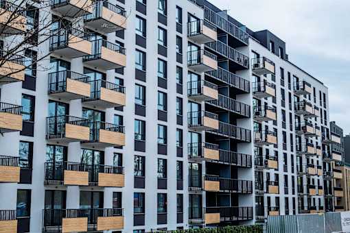 A modern apartment building with balconies and windows.