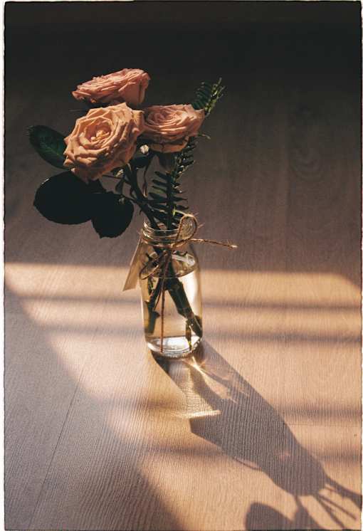 a bouquet of roses in a vase on a table