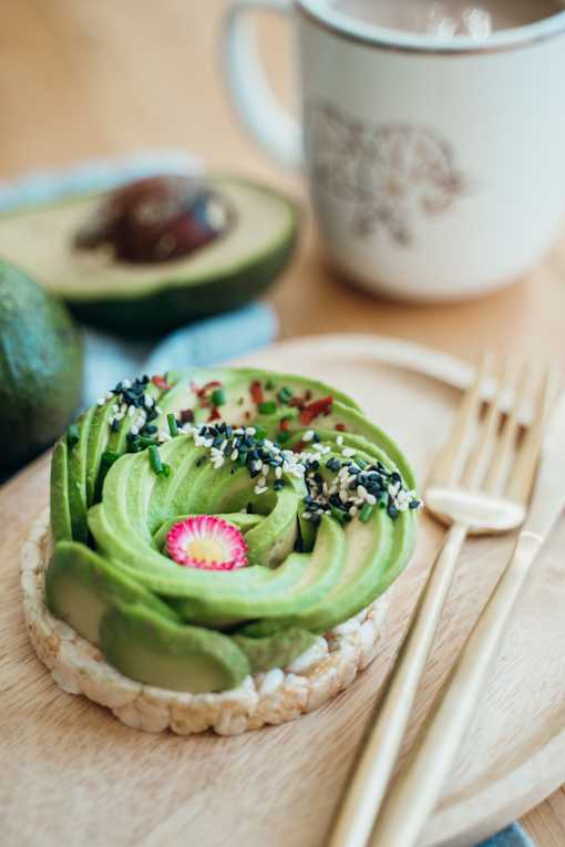 a piece of bread topped with avocado frosting and sprinkles