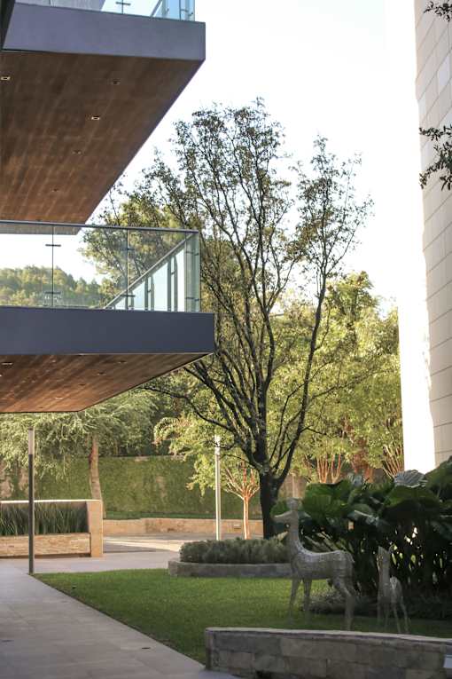 A modern building with a wooden roof and a glass balcony.