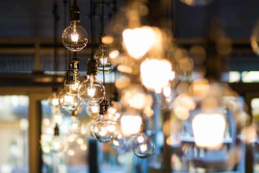 A chandelier with multiple light bulbs hanging from the ceiling.