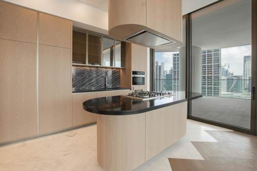 A modern kitchen with a large island and a view of the city.