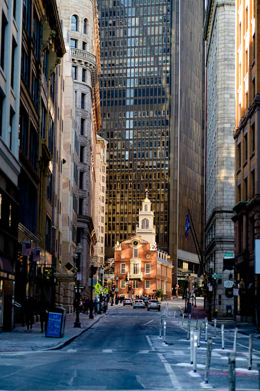 A city street with a church in the background.