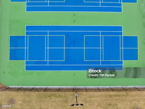 A tennis court with blue and green color.