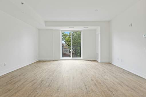 Empty room with wooden floor and white walls.