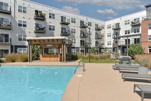 a swimming pool in front of an apartment building
