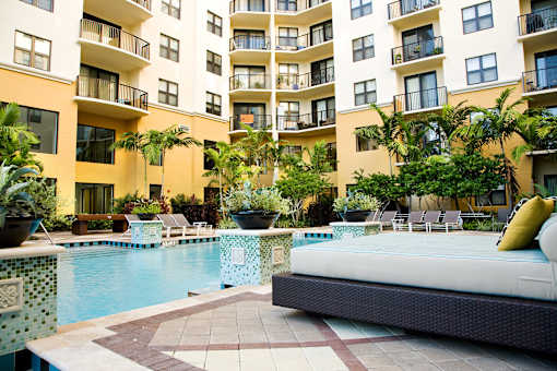 a large swimming pool in front of an apartment building