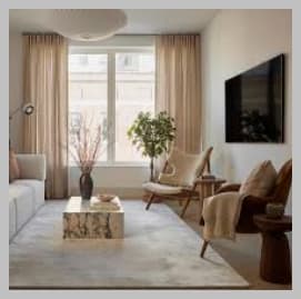 A living room with a white couch, a coffee table, a chair, and a plant.
