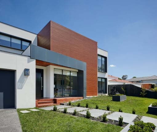 a modern house with a lawn and a grassy yard