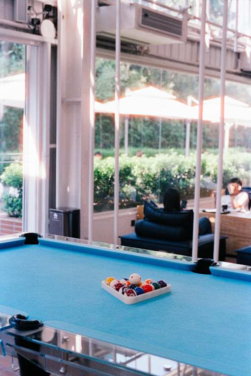 A pool table with a rack of balls on it.