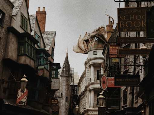 A dragon statue is on top of a building in a city.