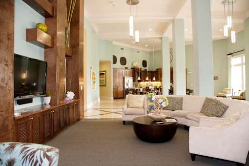 A living room with a white couch and a wooden entertainment center.