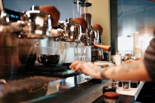 A person is making a drink at a bar.