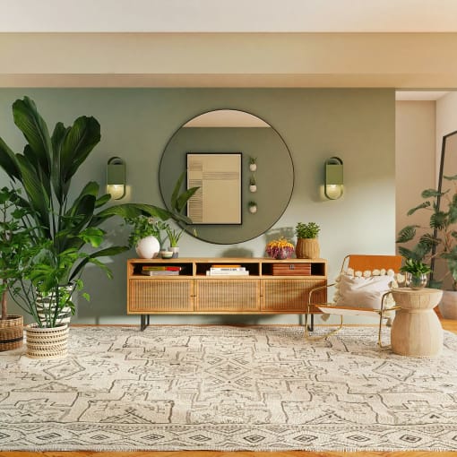 a living room with a couch and a mirror on the wall
