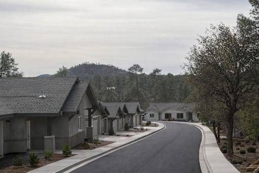 A row of houses with a curved road in front of them.