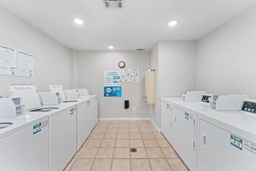 the laundry room is equipped with washers and dryers and has washing machines