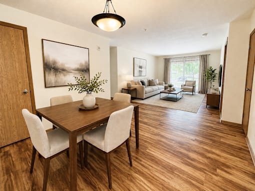 A dining room with a wooden table and chairs.