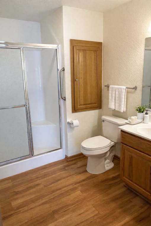 A white toilet sits next to a sink in a bathroom.