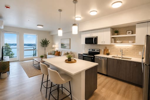A modern kitchen with a large island and bar stools.