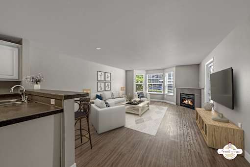 A modern living room with a fireplace and a television.