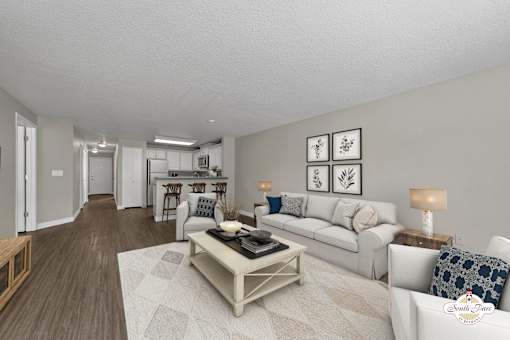 A living room with a white couch and a coffee table.