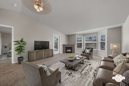 A living room with a fireplace and a television.