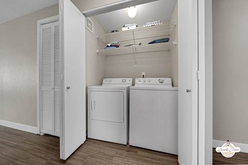 A small laundry room with a washer and dryer.
