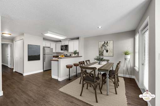 A modern kitchen with a dining table set for four.
