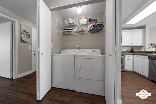 A small laundry room with a washer and dryer.