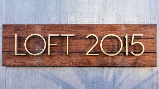A wooden sign with the letters "LOFT 2015" is displayed.