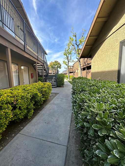 Walkway between buildings at Riverdale Apartment Homes in Hemet, California.