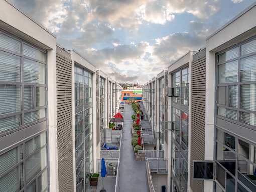 A long corridor with a red awning at the end.
