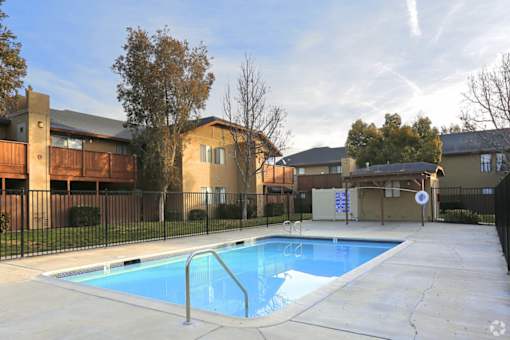 Crystal clear and inviting swimming pool at Riverdale Apartment Homes in Hemet, California.