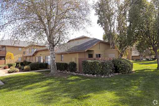Beautiful landscaping around apartment buildings at Riverdale Apartment Homes in Hemet, California.