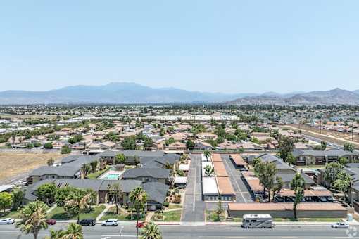 A residential area with houses and a mountain range in the background.