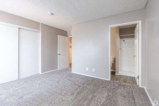 A room with a carpeted floor and white walls.