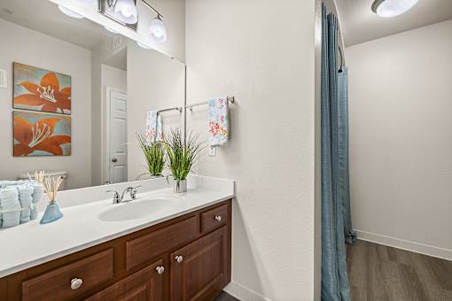A bathroom with a white sink and a blue towel.