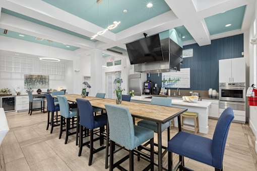 A modern kitchen with a dining table and chairs.