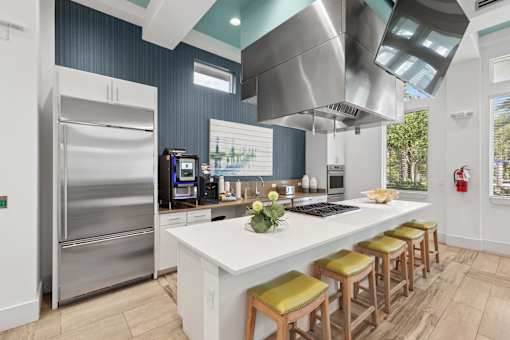 A modern kitchen with a large island and stainless steel appliances.