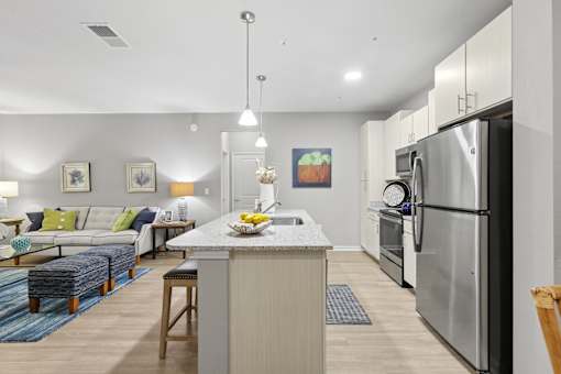 A modern kitchen with a refrigerator, oven, and microwave.