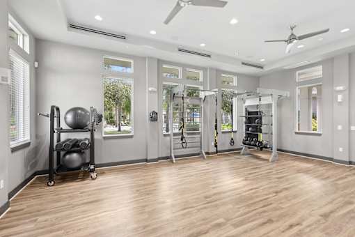 A spacious home gym with wooden floors and various exercise equipment.