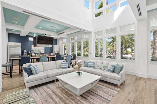 A modern living room with a white sofa and a coffee table.