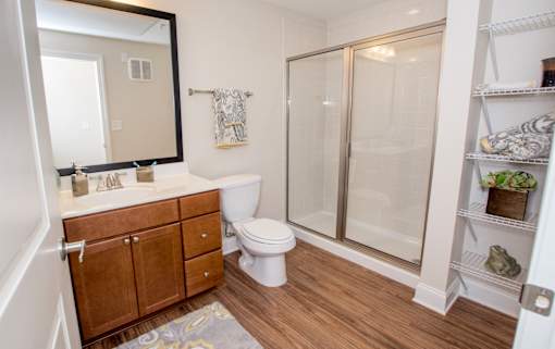 A bathroom with a toilet, sink, and shower.